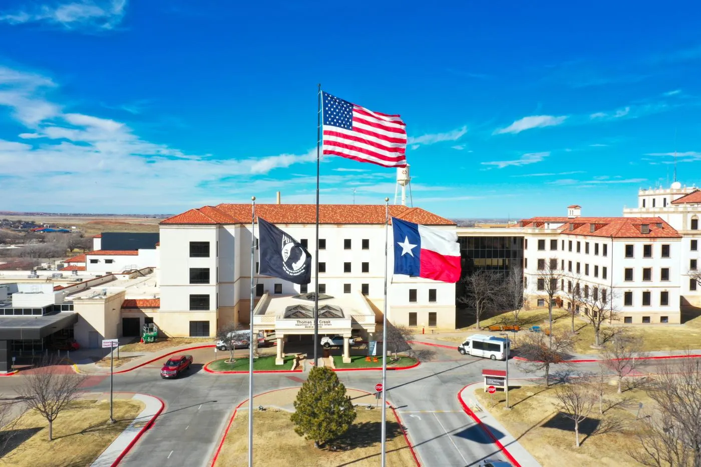 Aerial view of Thomas Creek Veterans Center with American, Texas, and POW/MIA flags flying.